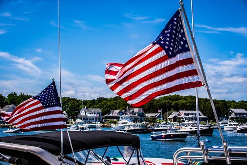 american flag flying over marina