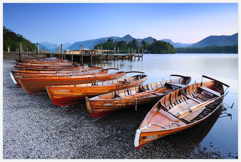 docked wooden boats on shore